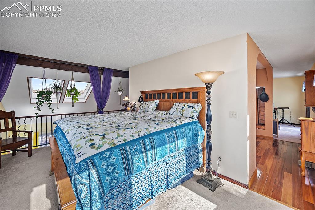 Master bedroom with bathroom and office/extra space in the background. Skylights with view of Garden of the Gods.
