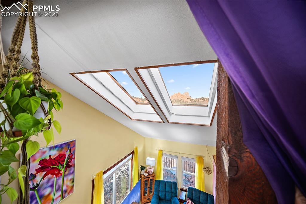 Master bedroom view overlooking main floor living room with a view of Garden of the Gods through skylights.