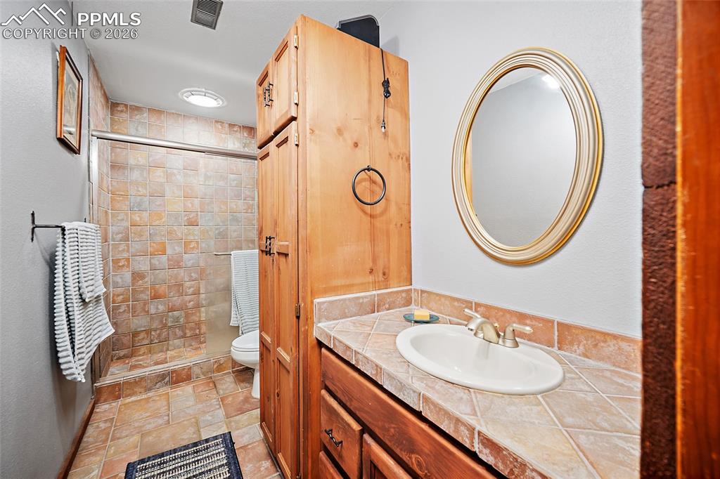 Bathroom on the bottom floor of home, just across from the 2nd bedroom.