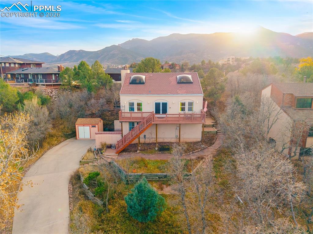 Front of home with the Front Range and Pike's Peak in the background.