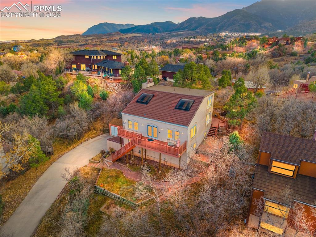 Twilight enhanced shot of front of home looking southwest with the Front Range in the background.