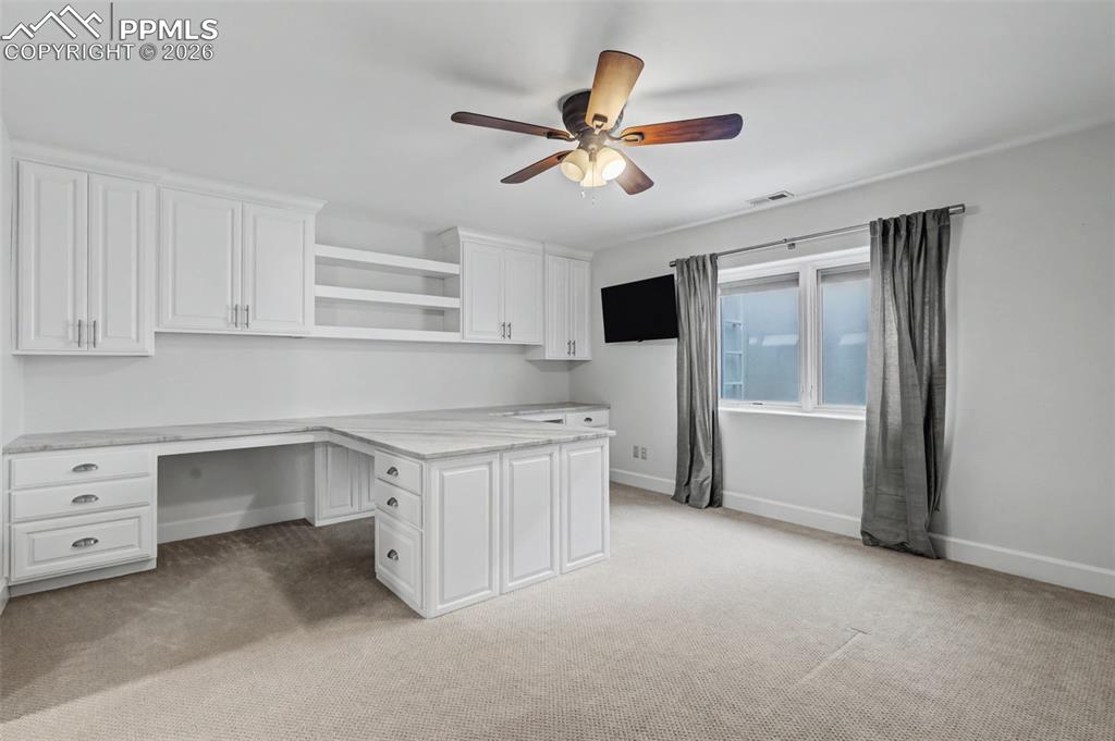 Bedroom has a Murphy bed and custom built office space