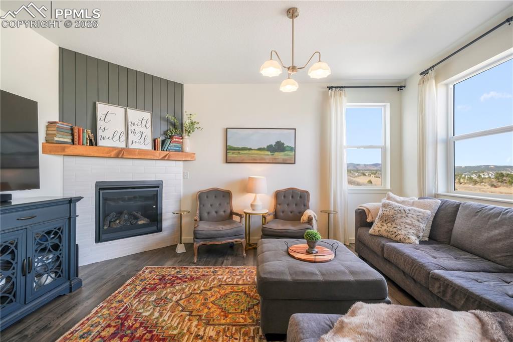 Main level living room with abundant light, gas fireplace