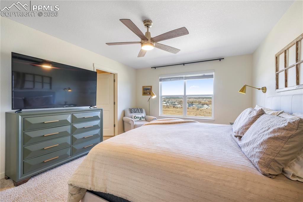 Upstairs primary bedroom with space for seating area, ensuite bathroom and views 