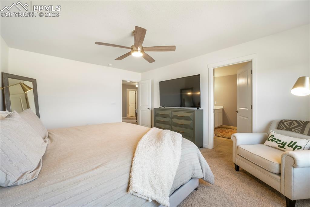 Upstairs primary bedroom with space for seating area, ensuite bathroom and views 