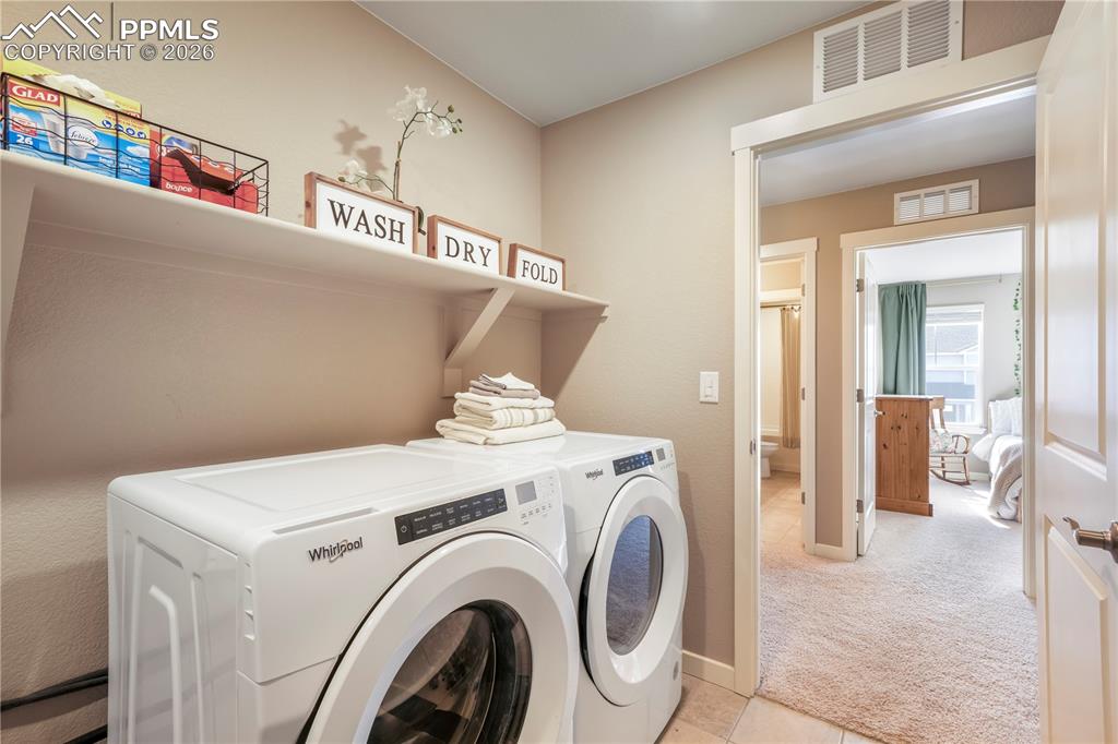 Upstairs laundry area with tile floors