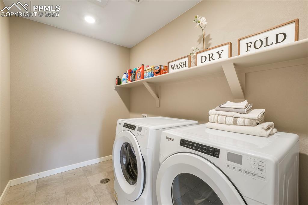 Upstairs laundry area with tile floors