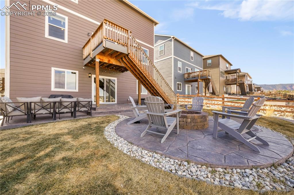 Backyard with gas firepit, fenced yard, tiered stamp concrete patio areas and hot tub