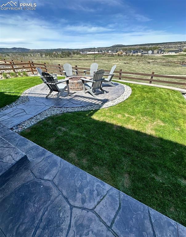 Backyard with gas firepit, fenced yard, tiered stamp concrete patio areas and hot tub