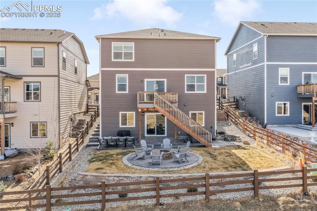 Backyard with gas firepit, fenced yard, tiered stamp concrete patio areas and hot tub