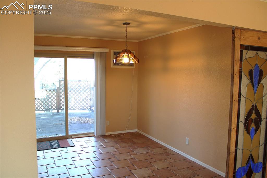 Dining area with ornamental molding and a textured ceiling