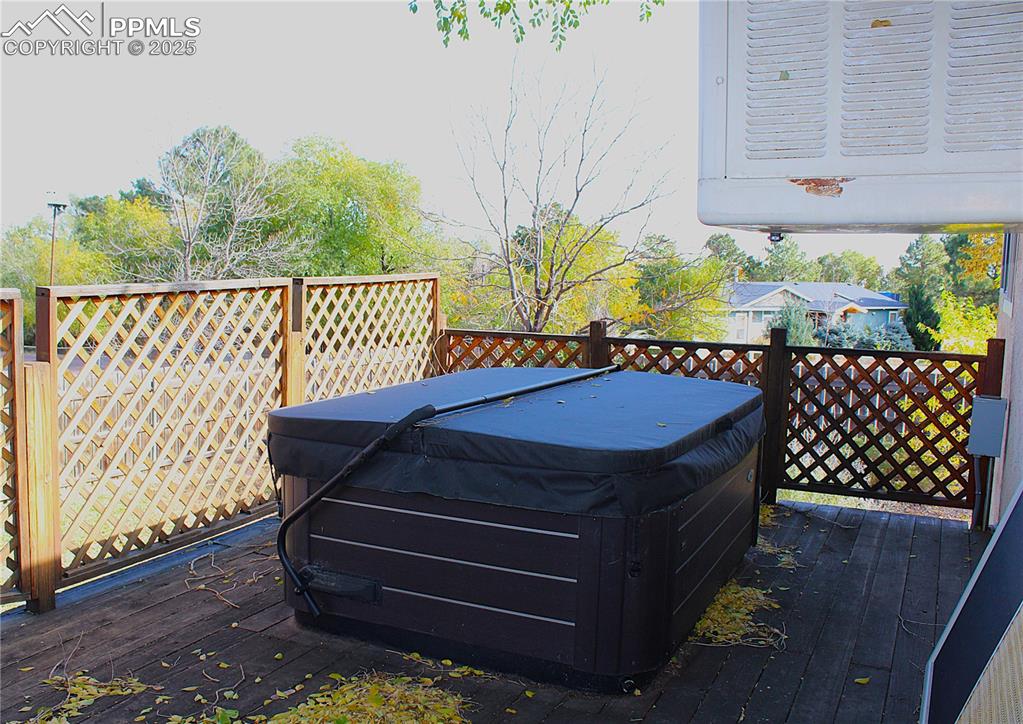 Wooden deck featuring a 3-yr old hot tub