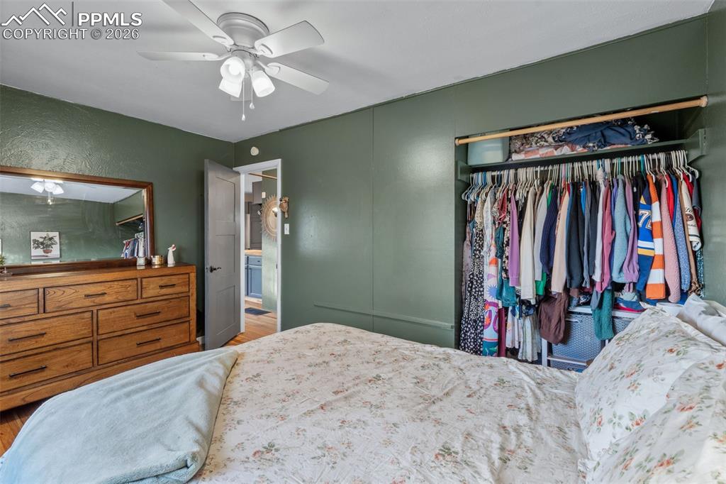 Bedroom featuring a closet, a ceiling fan, and wood finished floors