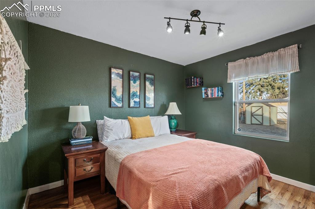 Bedroom with baseboards and wood finished floors