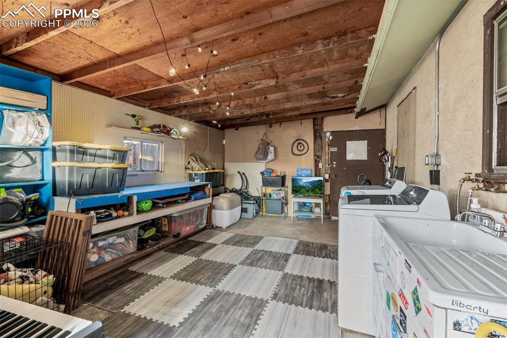Laundry area featuring concrete flooring and a wall mounted AC