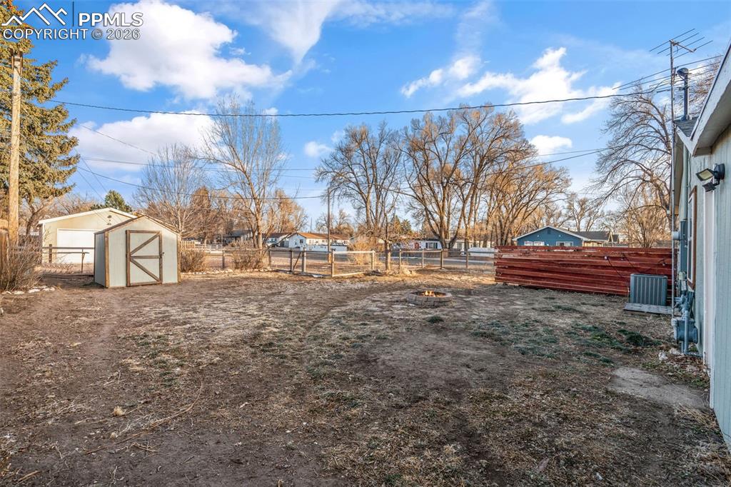Fenced backyard with a shed