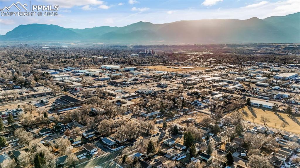 View of property location with a mountain backdrop and nearby suburban area