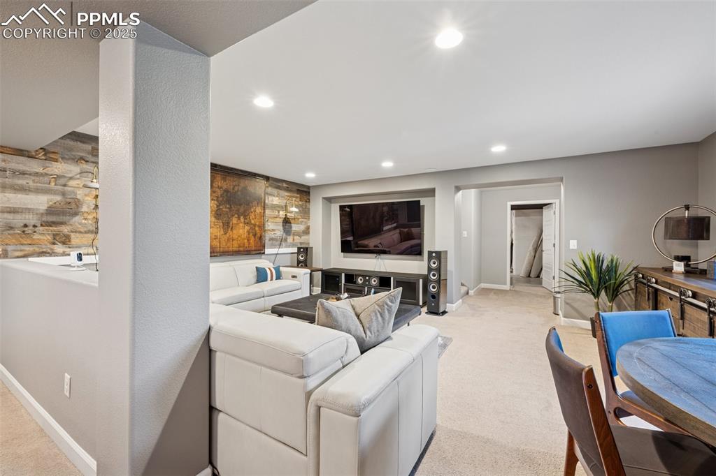 Living area featuring light carpet and recessed lighting