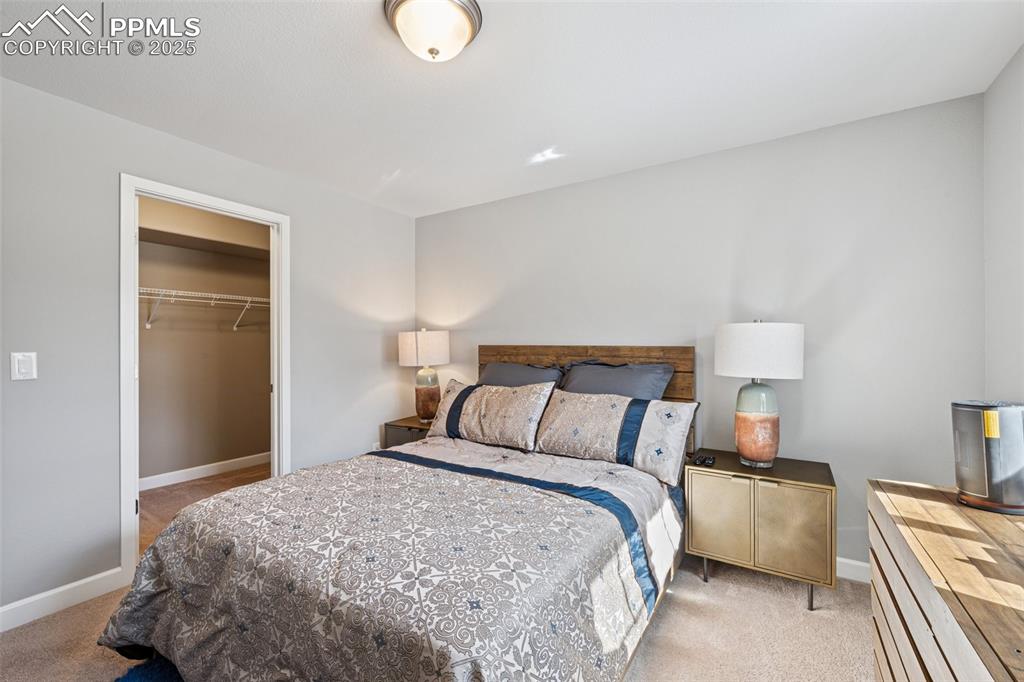 Bedroom featuring light colored carpet and a closet