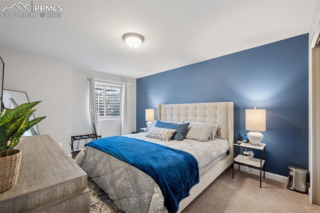 Carpeted bedroom featuring baseboards