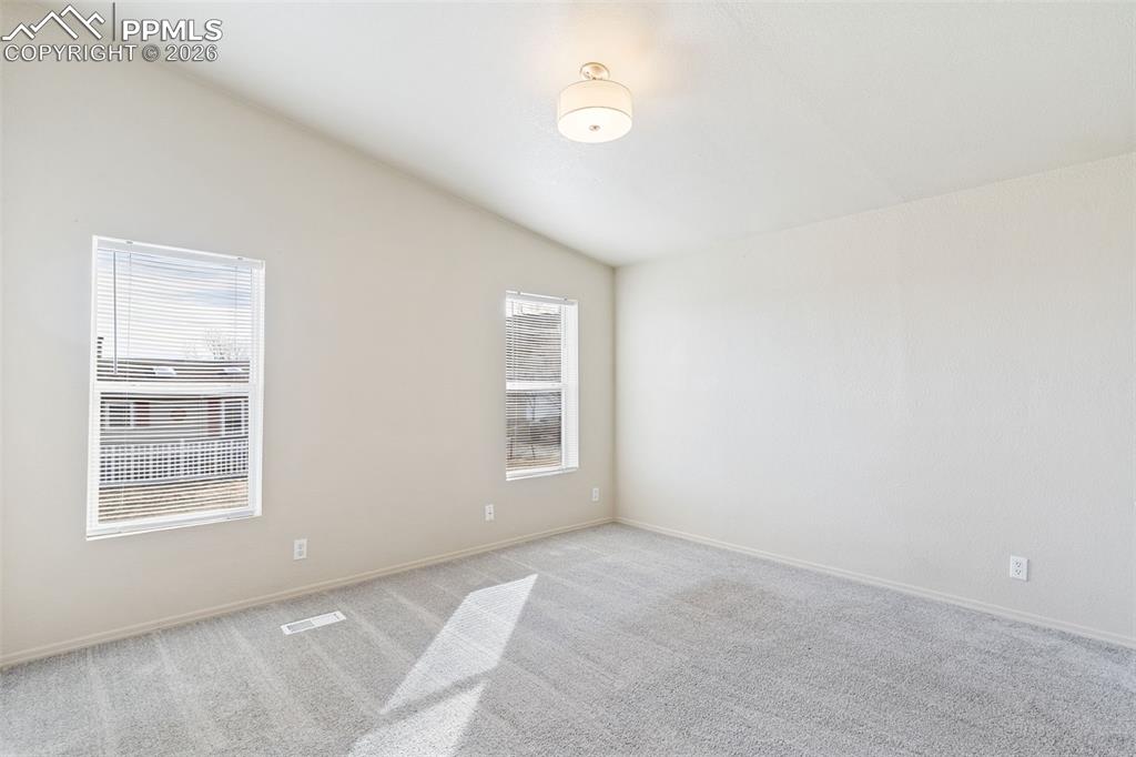 Primary bedroom with vaulted ceiling.  You'll enjoy the oversized closet and en suite full bath. 