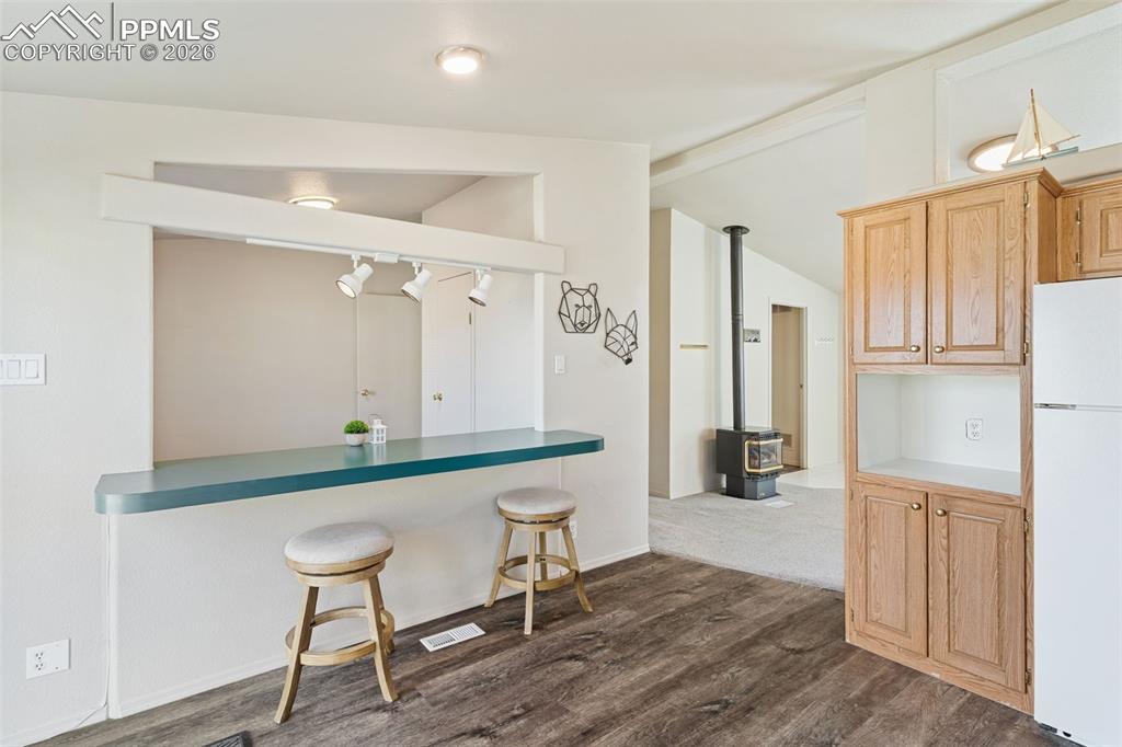 Kitchen with counter bar that looks into the 3rd bedroom / office. 