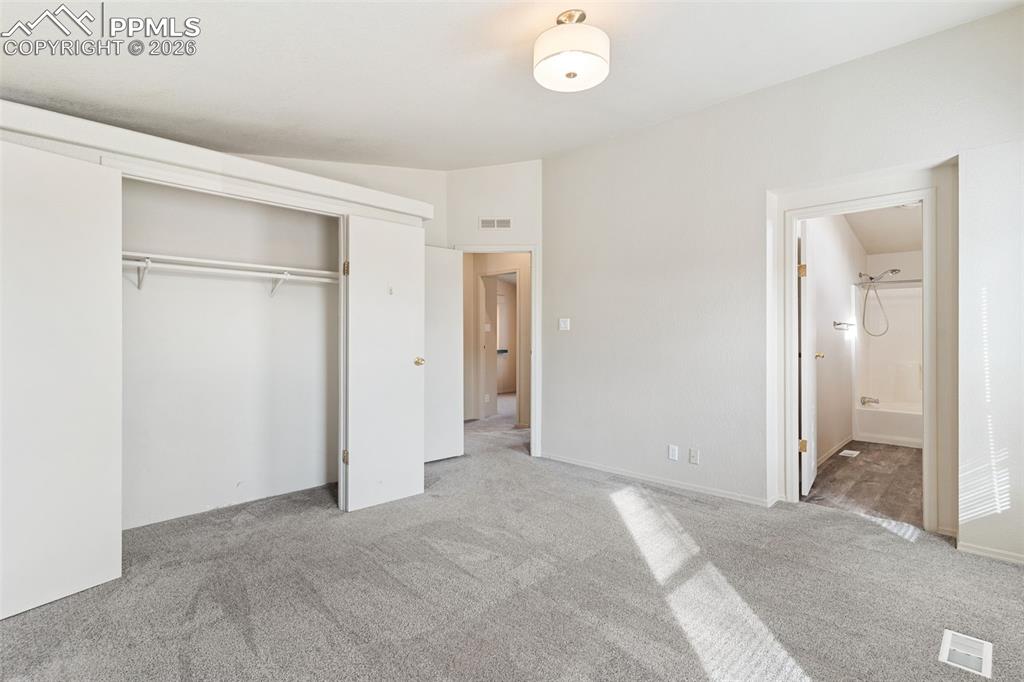 Primary bedroom with vaulted ceilings, oversized closet and en suite full bath