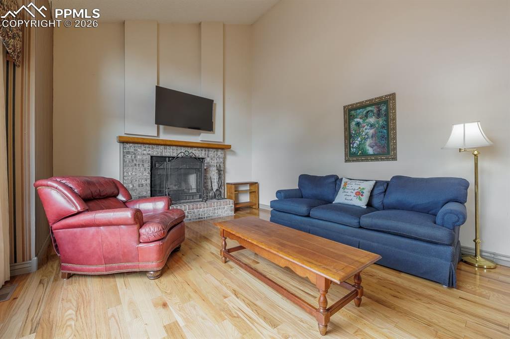 Family room off of kitchen and nook with brick surround wood burning fireplace