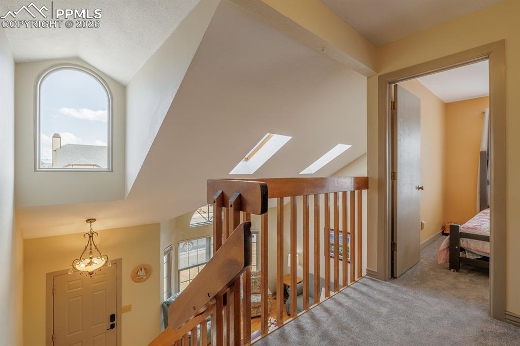 Upstairs hallway with abundance of natural light. Two bedrooms and jack and jill bath on one end and primary retreat on the other end