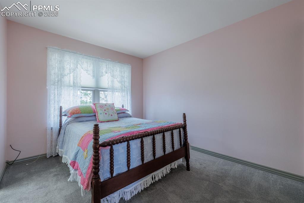 One of two bedrooms on upper level at other end of hall