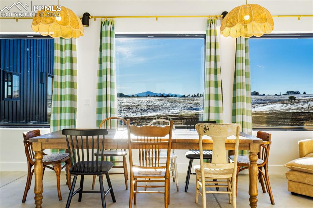 Dining space featuring finished concrete floors and a mountain view