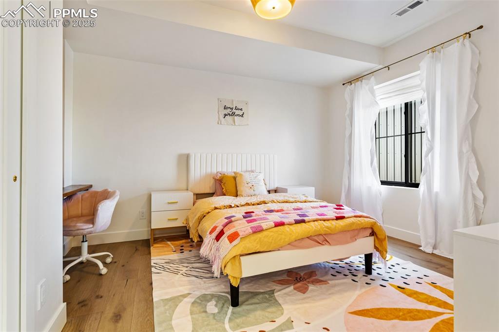 Bedroom featuring wood finished floors and baseboards