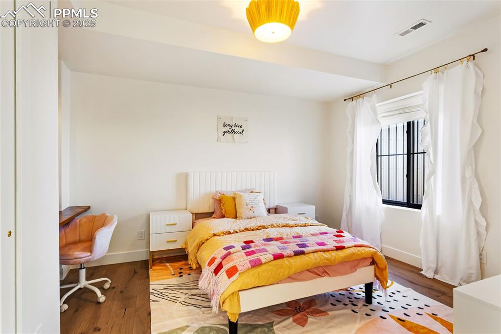 Bedroom featuring baseboards and wood finished floors
