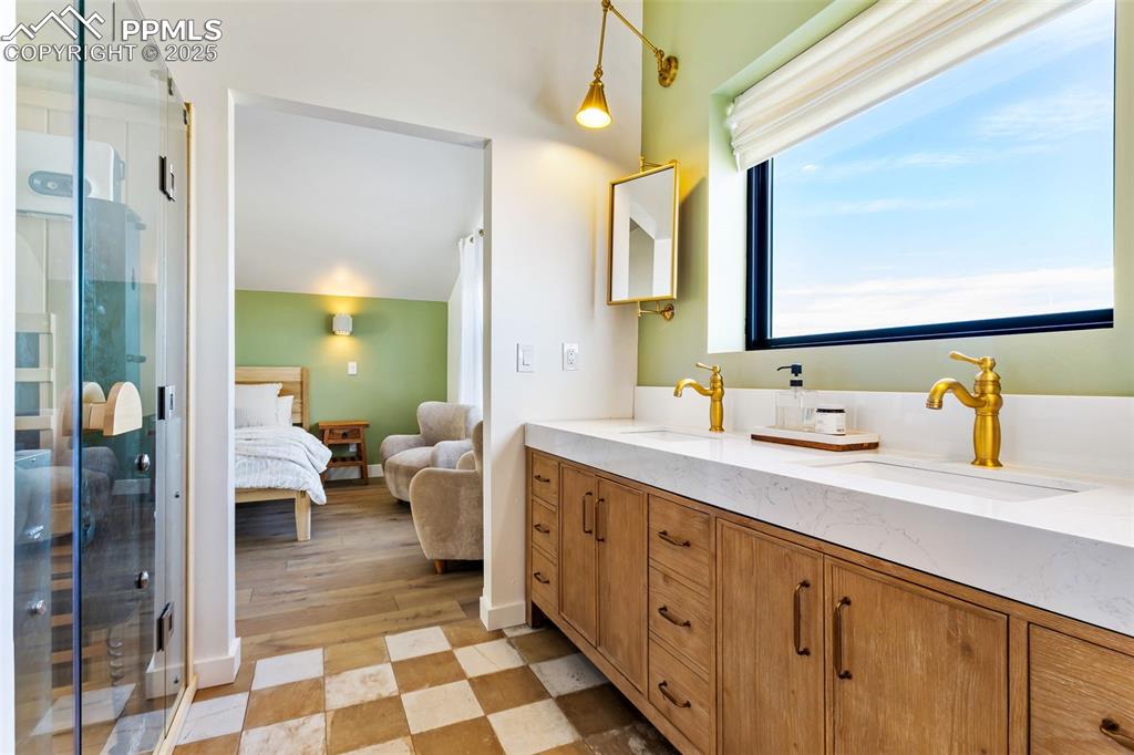 Ensuite bathroom with double vanity and a shower stall