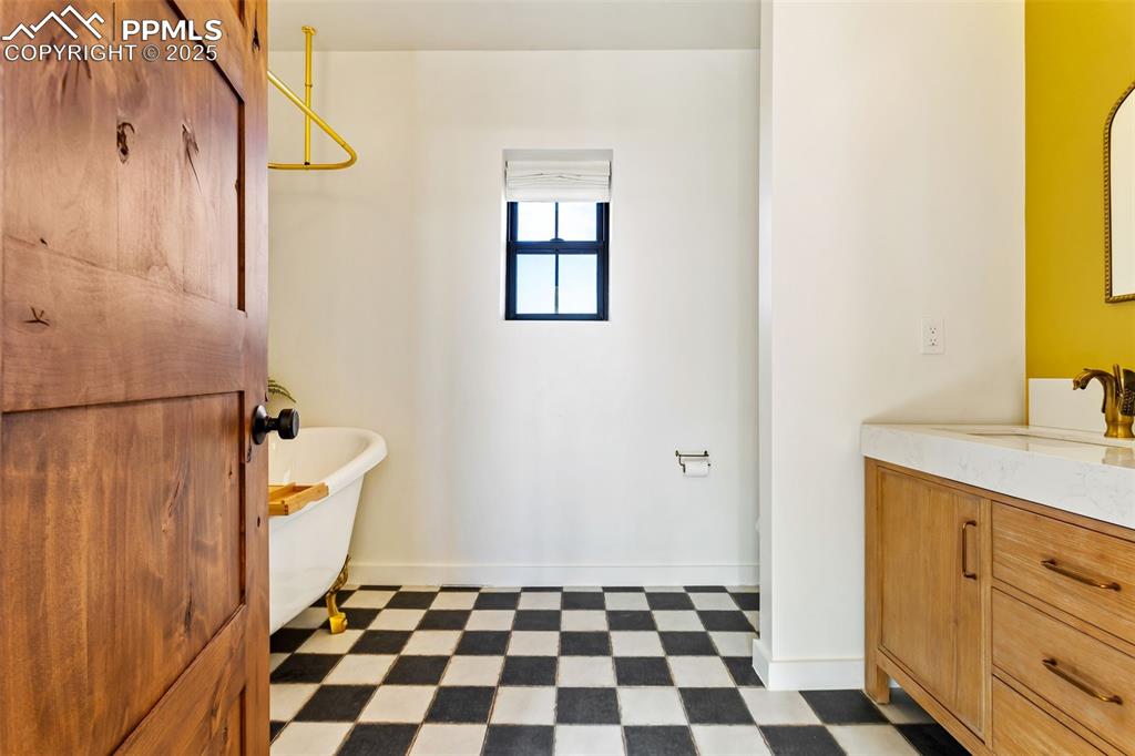 Bathroom featuring dark flooring and vanity