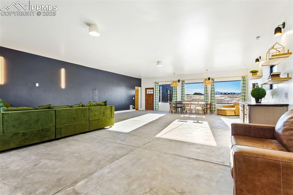 Living room featuring finished concrete floors