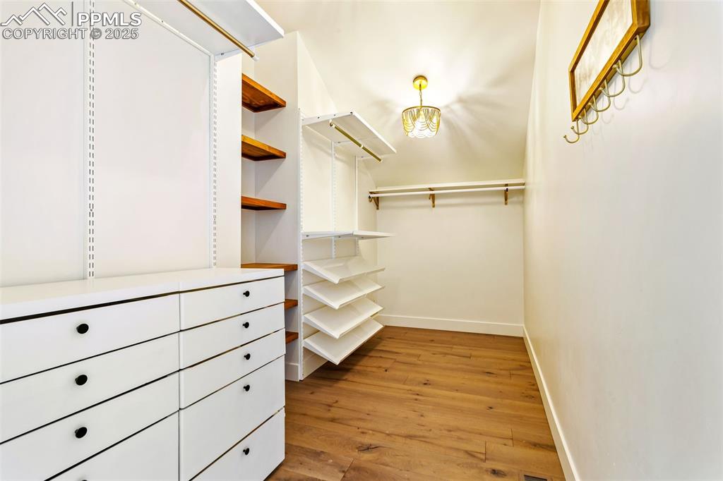 Spacious closet with light wood-type flooring