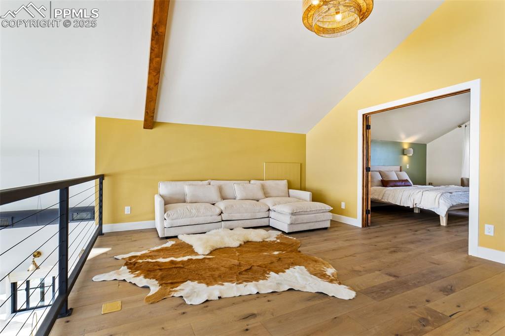 Living room featuring hardwood / wood-style floors and baseboards