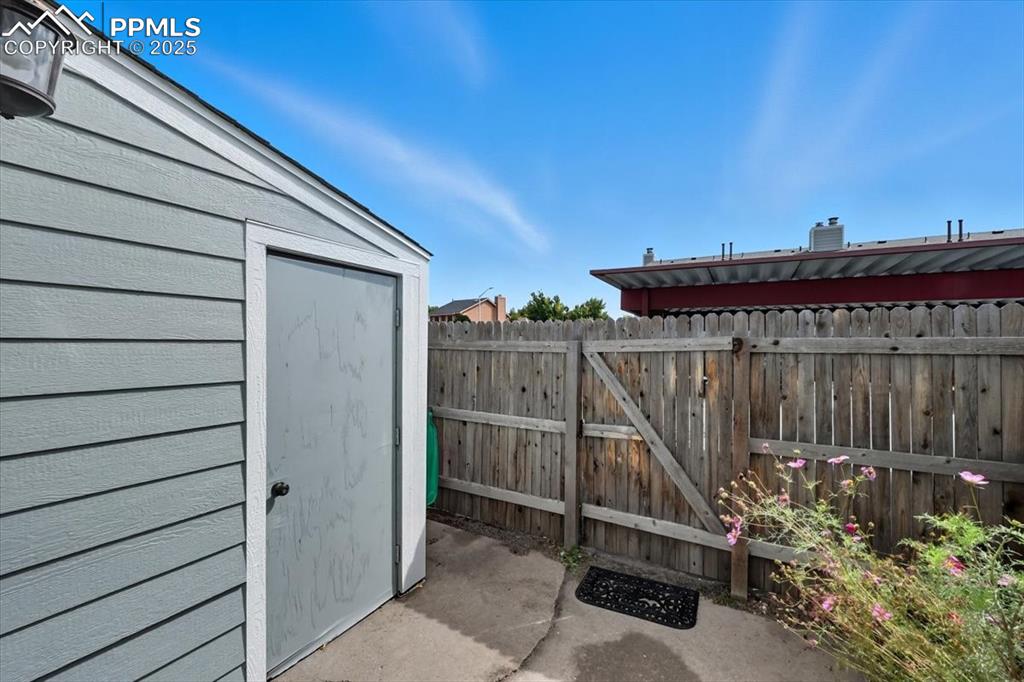 View of patio / terrace featuring a storage unit