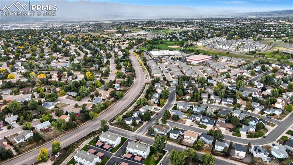 Aerial view of property's location featuring nearby suburban area and a mountainous background