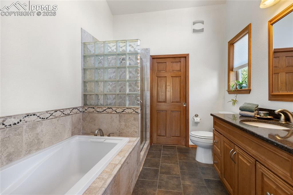 Primary bedroom bath is extra roomy with tub plus shower, vaulted ceilings