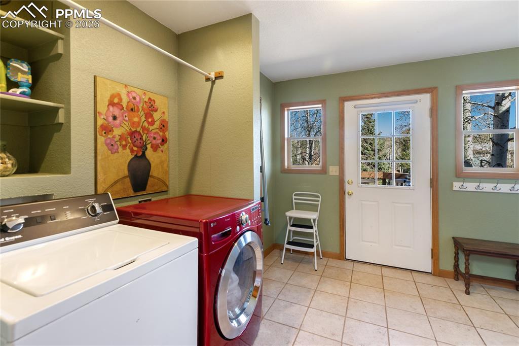 Laundry is very large and on main level same as primary. Convenient back yard entrance from here so dogs and kids can come in from play and drop off coats and shoes before coming inside. 