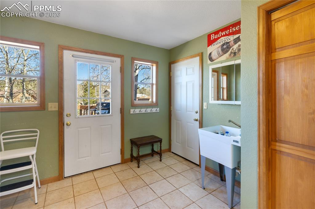 Laundry is very large and on main level same as primary. Convenient back yard entrance from here so dogs and kids can come in from play and drop off coats and shoes before coming inside. 