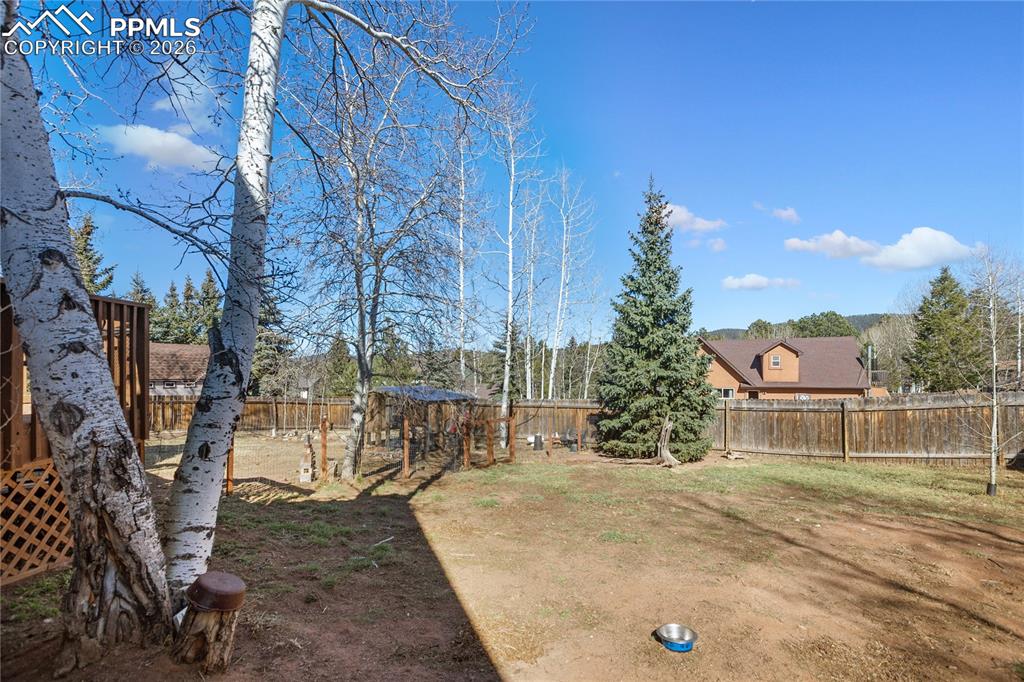 Yard is already divided for you between chicken and garden beds with dog area on other side.