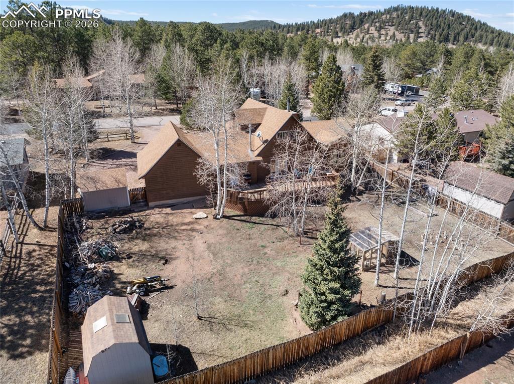 Back yard is fully fenced and set up perfectly with sheds, chicken coop, garden beds, and dog run.