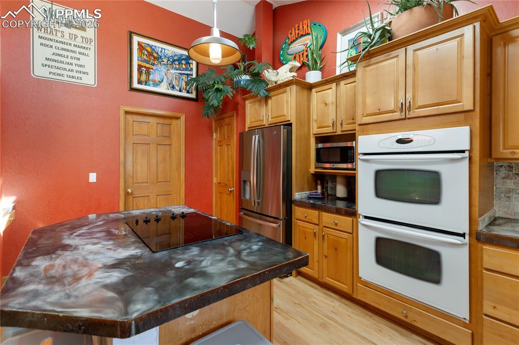 Kitchen is updated! Stainless steel appliances, concrete counters, vaulted ceilings, recessed lighting, skylights, hard wood floors, open and spacious, a dream come true