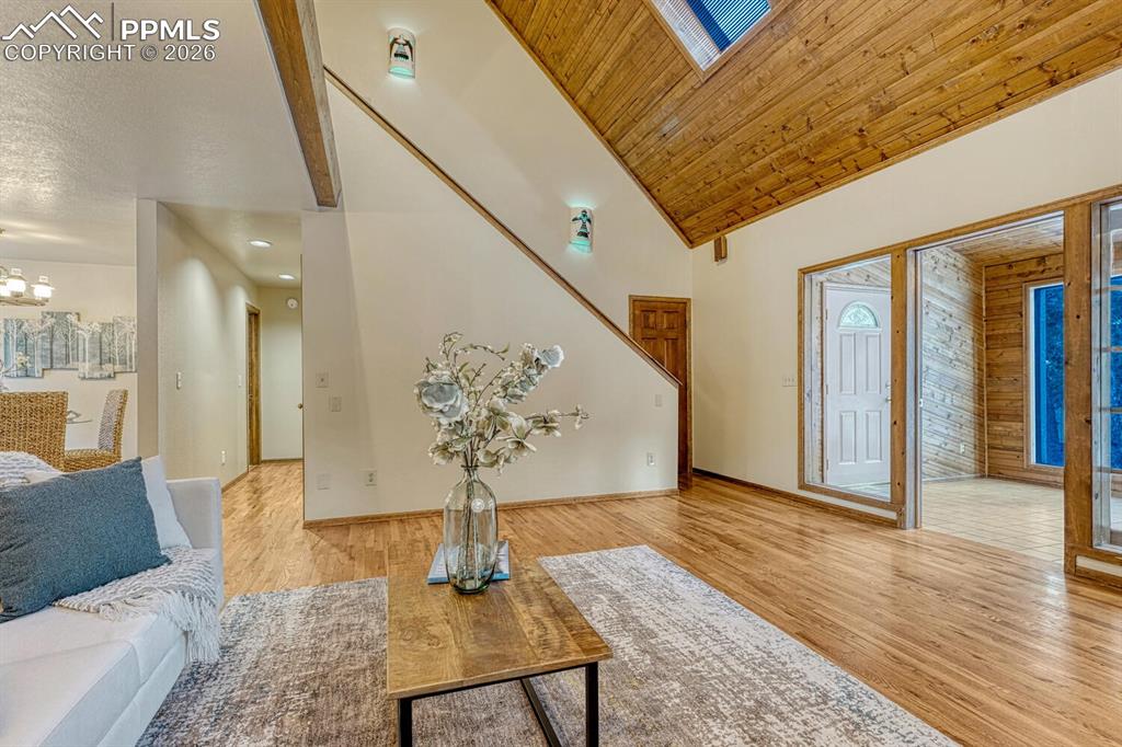 Living room looking at stairs to top level with primary bedroom and loft