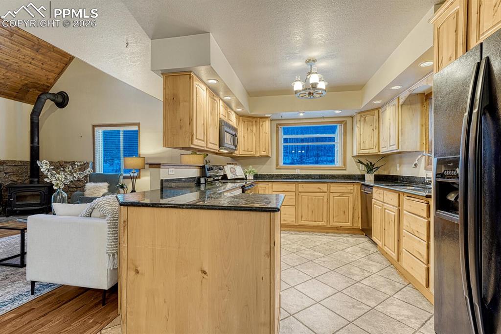 Kitchen with granite and black appliances