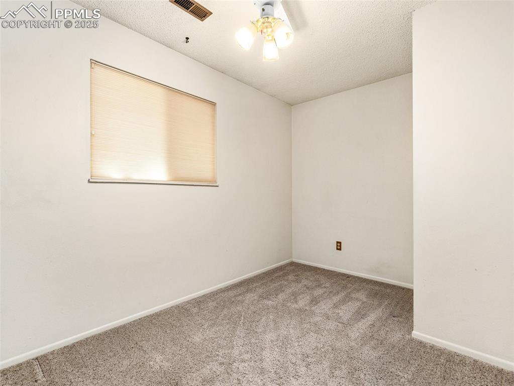 Carpeted spare room with a textured ceiling