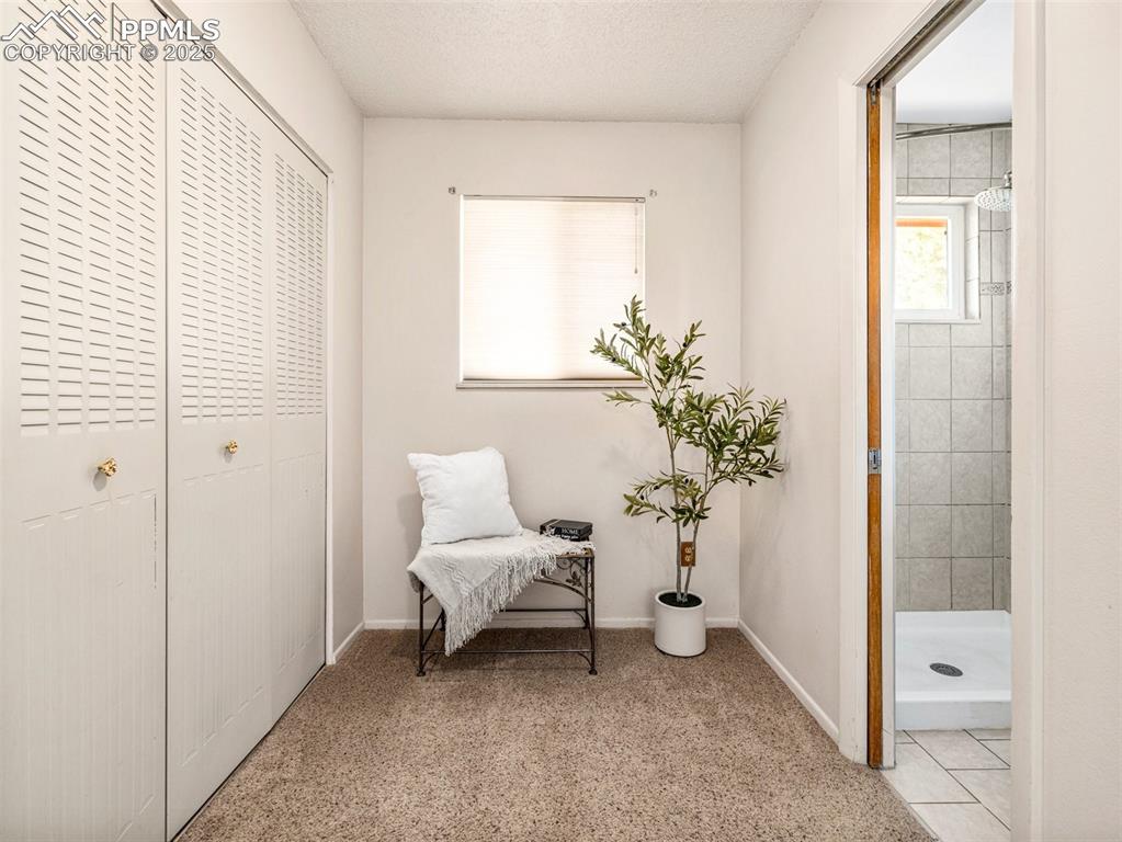 Sitting room with baseboards and a textured ceiling